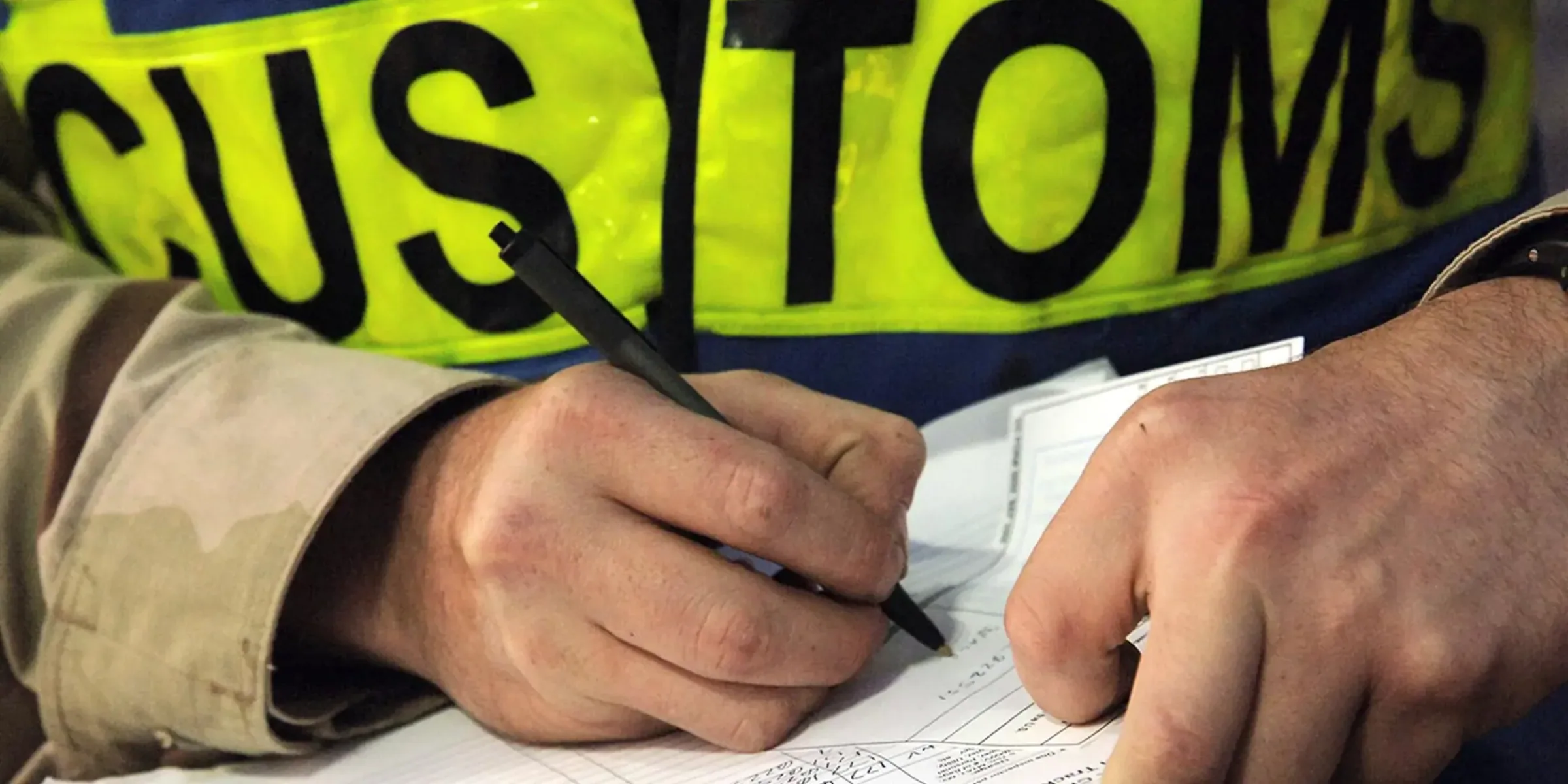 Customs worker completing shipping documentation