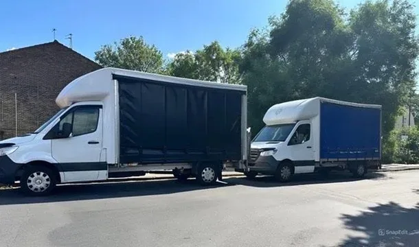 Two Compass Cargo curtain-side vans parked on a London street