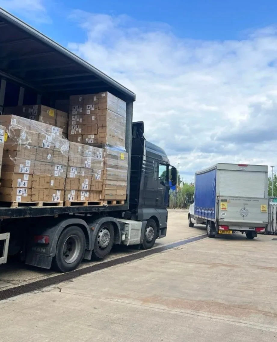 Palletised cartons being loaded beside a truck
